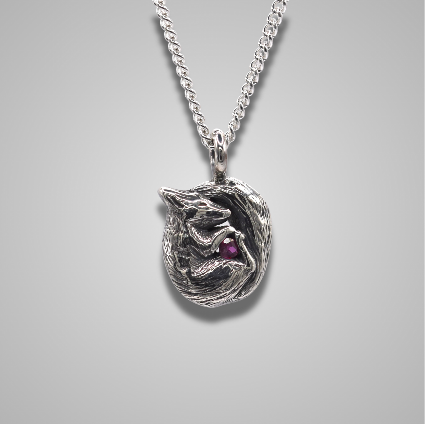 A curled up squirrel snuggling a gemstone. The squirrel is realistic and detailed. The sparkly stone is a ruby. 